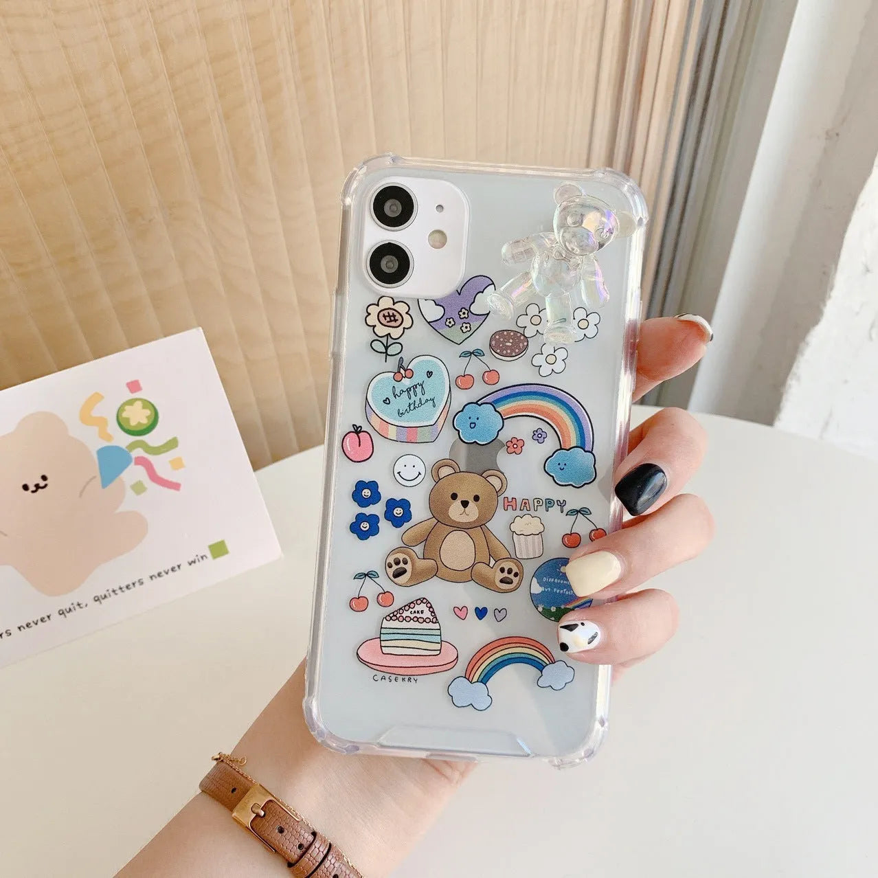 Bear chain and pendant attached to a Japanese Korean cartoon style protective case for an iPhone.