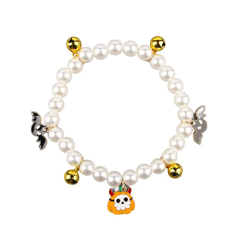 Halloween decorative pet collar with simulated pearls and a choice of pumpkin-themed charms: purple ghost, skull, or smiling.