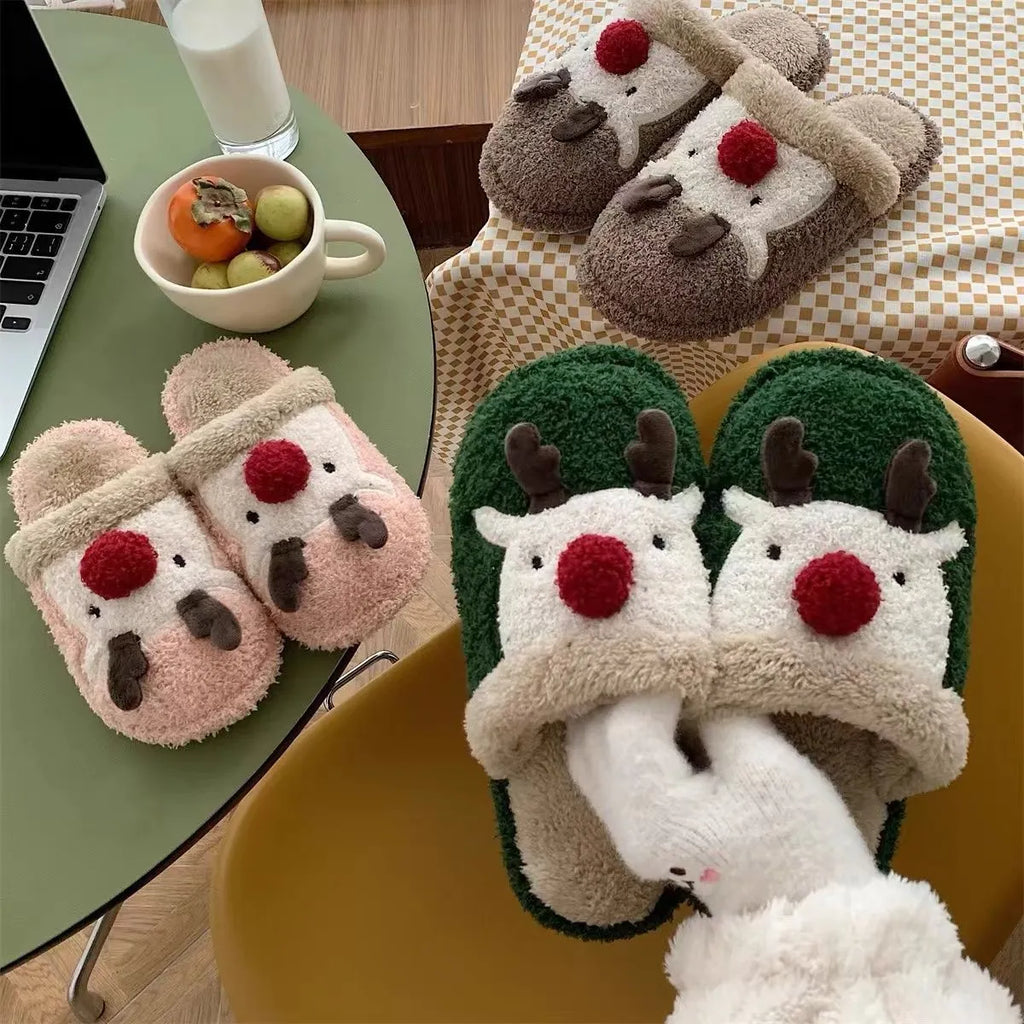 Women's Christmas deer patterned cotton slippers with anti-slip soles in brown, pink and green colours.