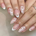 Short almond shaped French style false nails with glitter and floral patterns C625 colour