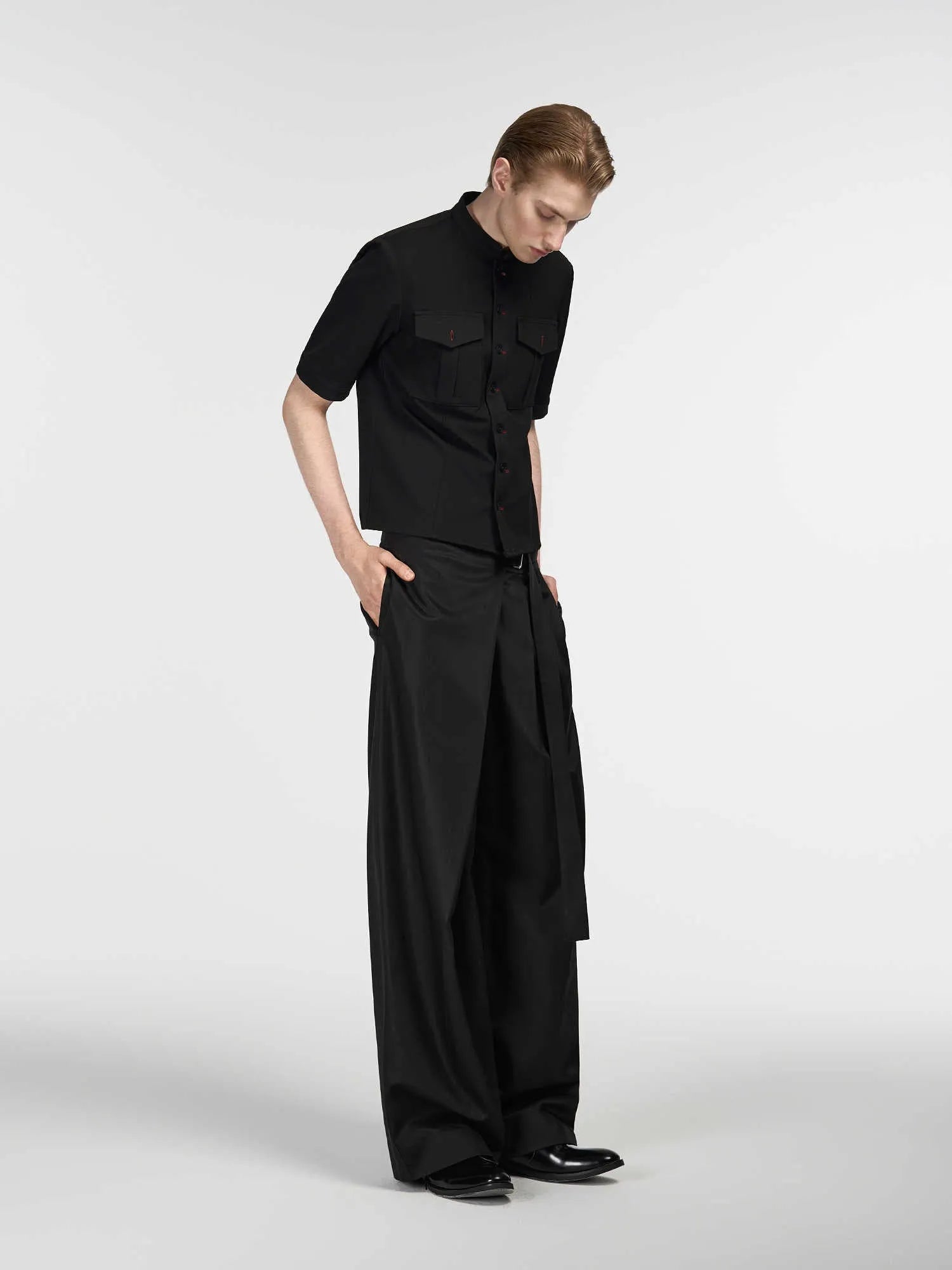 Black straight-leg trousers with adjustable waistband and single-pleat front detail