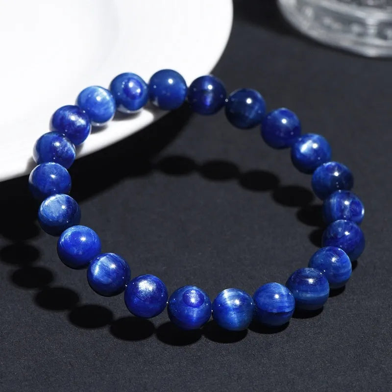 Natural blue crystal ball bracelet with geometric Ruyi design on a wrist.