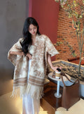 Women's polyester scarf cape with tassel trim in a free size shawl style.