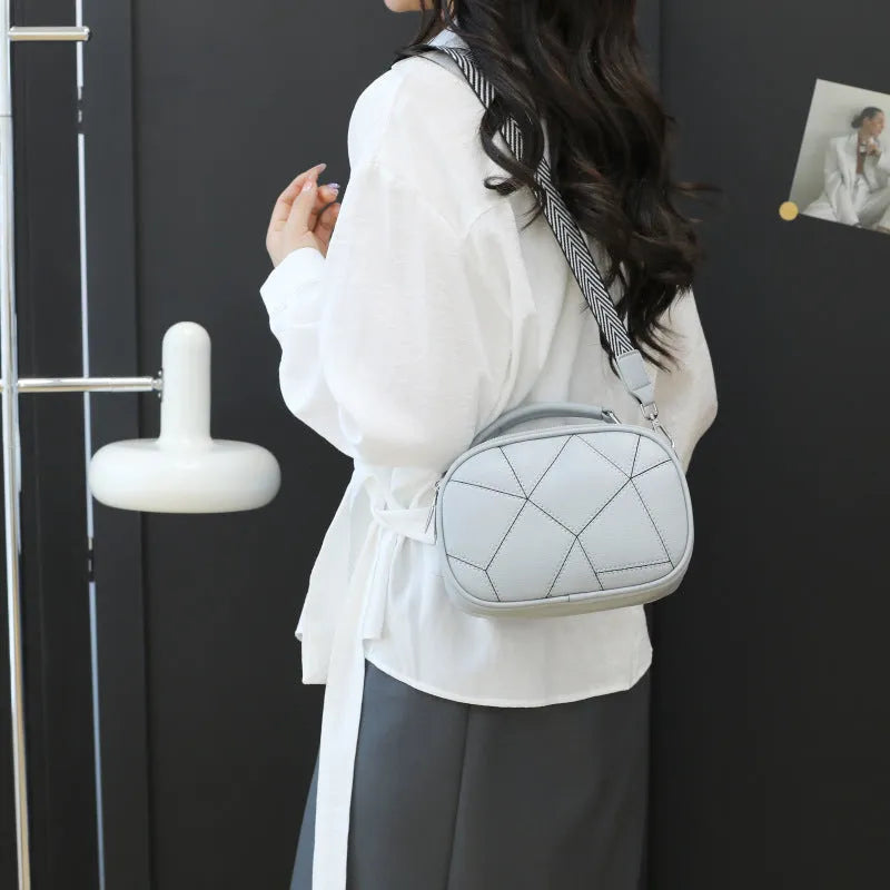 Gray three-layer patchwork small round bag with visible stitching, shown with beige, black, white, and blue colour options.