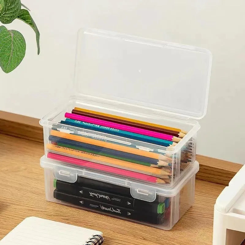 Clear plastic pencil storage box filled with colouring pencils and wax crayons.