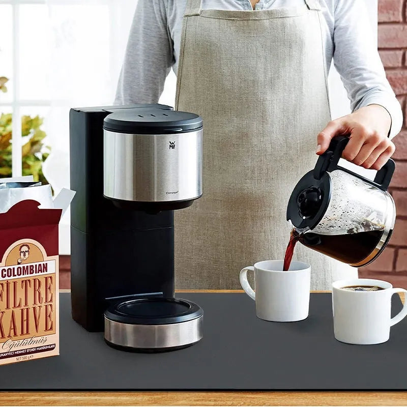 Square super absorbent drain mat with rubber backing in black or blue on a kitchen counter.