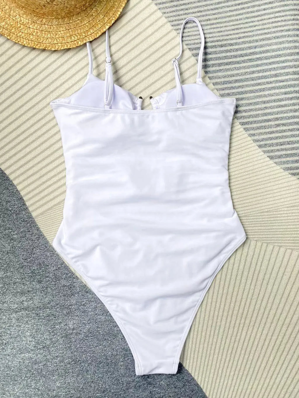Black solid colour one-piece swimsuit for women on a mannequin, showing a tight fit.