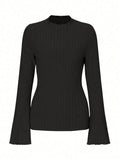 A black long sleeve slim fit top with round neck and lantern sleeves on a model.