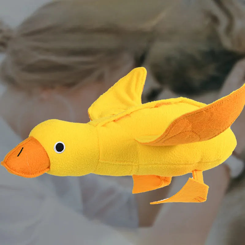 Yellow teddy duck dog toy with food leak openings for treat dispensing during training and play