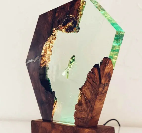 Resin luminous diver and humpback whale night light with USB cable on a shelf