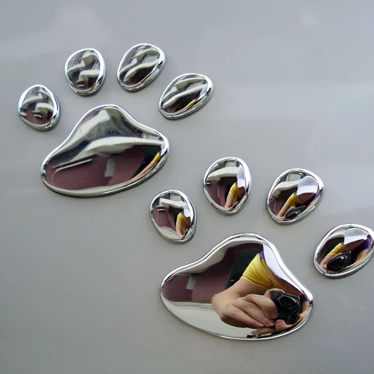 PVC car sticker pair featuring hand-shaped brush dog footprints design in choice of colours