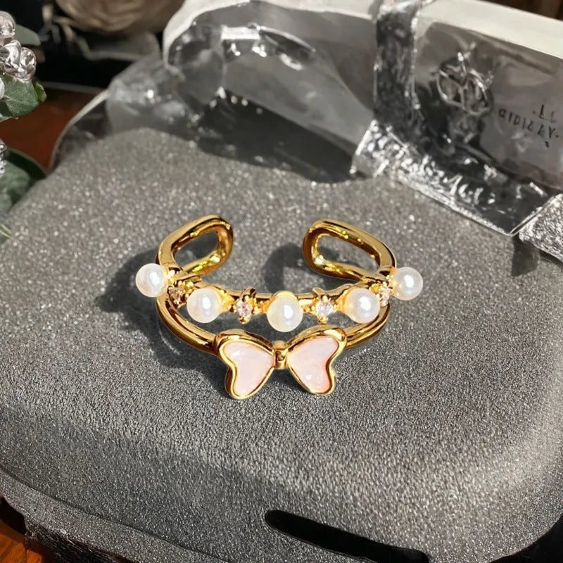 Adjustable vintage-style copper ring with inlaid zircon stones, featuring gourd, flower, and bow shapes.