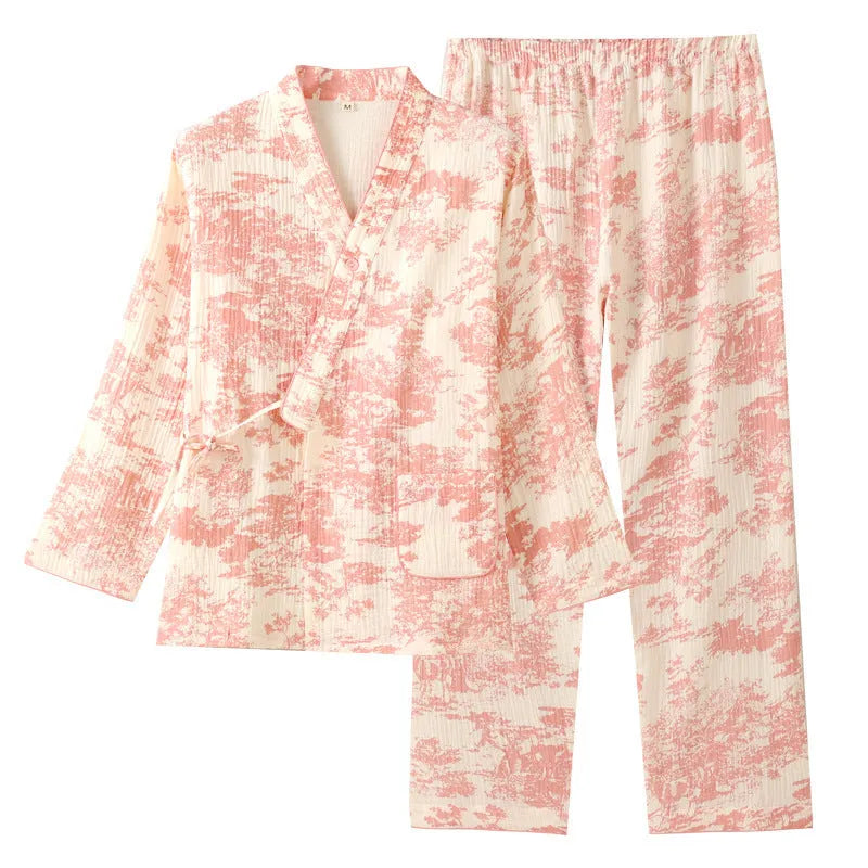 Women's pink cotton gauze lounge suit set with long sleeves and trousers laid flat.