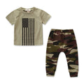 A little boy wearing a green camouflage short-sleeve shirt and matching trousers, a casual two-piece summer suit set.