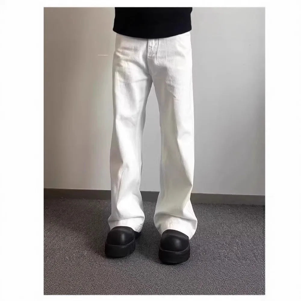 Men's loose straight wide leg white cotton denim jeans on a plain background