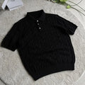 Short sleeve twisted knit summer T-shirt in light gray on a hanger