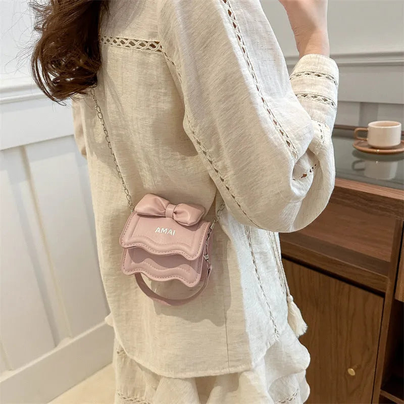 Mini crossbody bag in PU leather with adjustable strap, shown in multiple colour options