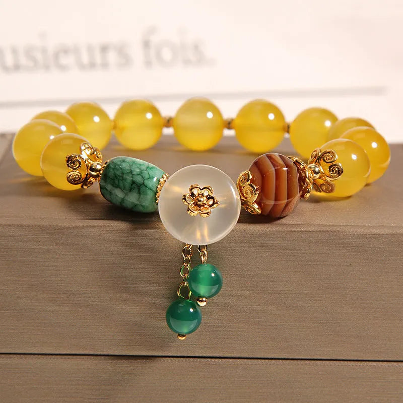 Yellow agate stone bracelet for women with gold silk threading on a wrist