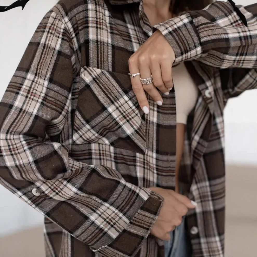 Dark brown striped women's long sleeve shirt in retro style on a hanger
