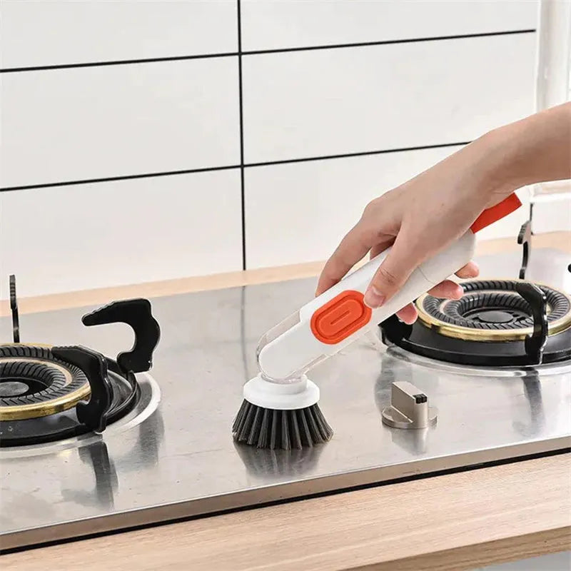 White and red long-handle kitchen brush with liquid dispenser button and two removable brush heads.