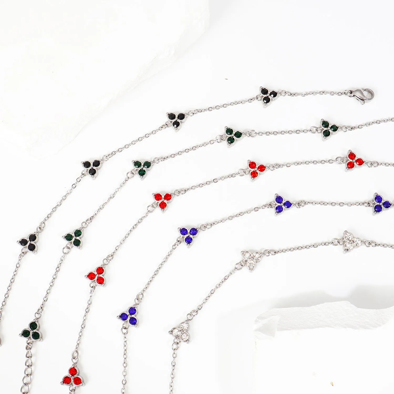 Women's stainless steel geometric bracelet with three diamond triangle design and coloured stone accents