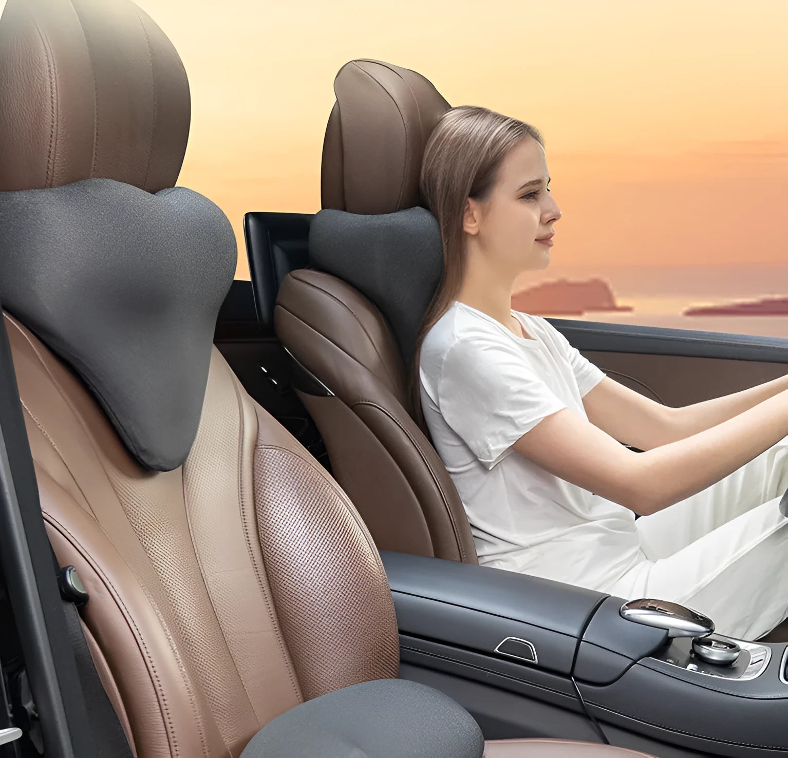Dark grey memory foam car headrest pillow shown on car seat, measuring 67x10x27.5 cm.