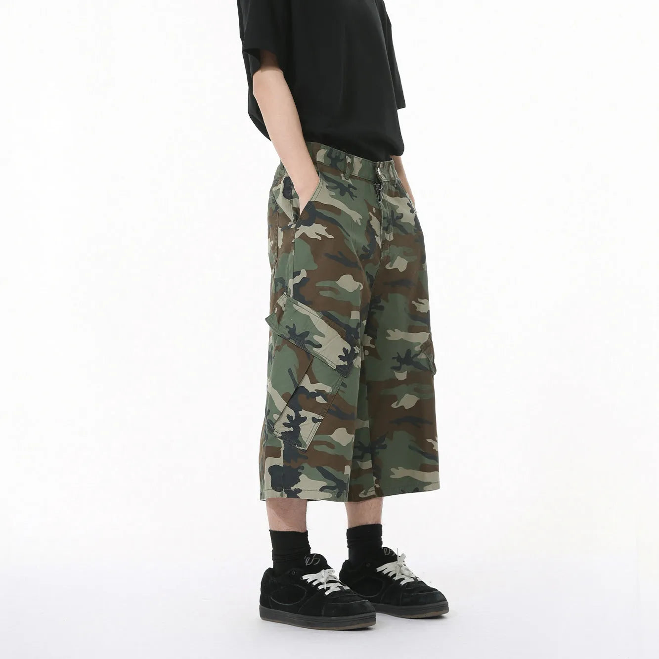 Men's camouflage pattern cotton trousers with wide leg design and cropped length showing side stitching detail