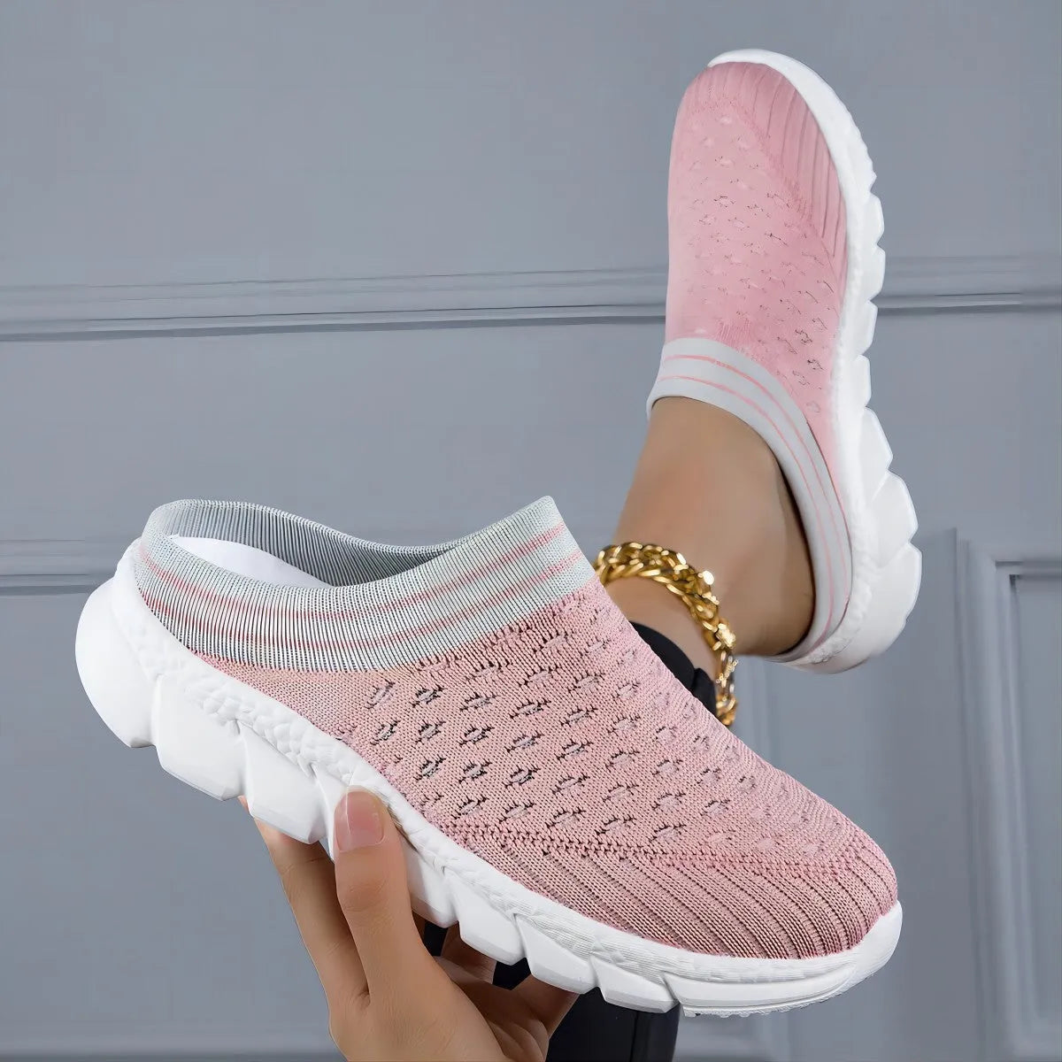 Women's black striped Flyknit slipper shoes with hollowed-out design on a viscose sole.