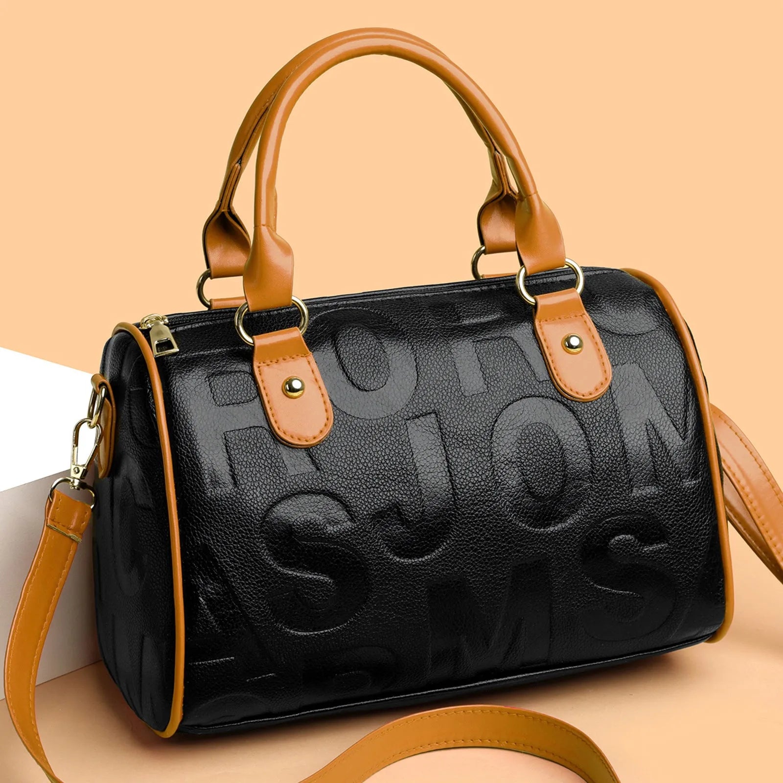 Brown cylindrical PU crossbody bag with three adjustable shoulder straps on a plain background.