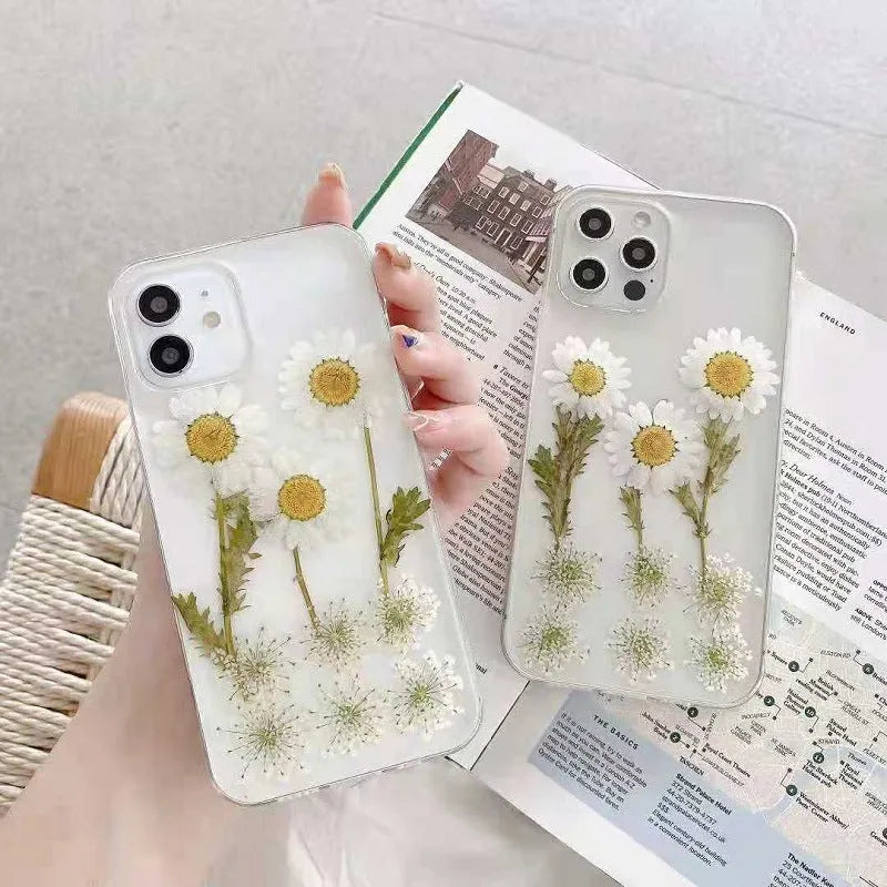 White epoxy daisy floral pattern on a glass back iPhone protective case.