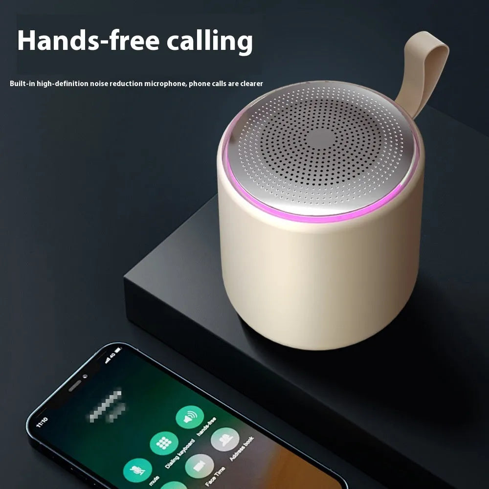 Bluetooth mini portable speaker in beige, front view, with compact design and visible speaker grille