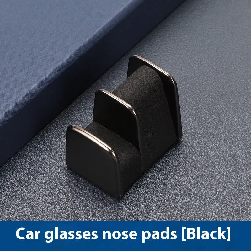 Zinc alloy and leather car dashboard glasses clip holder in green, shown on a car dashboard.