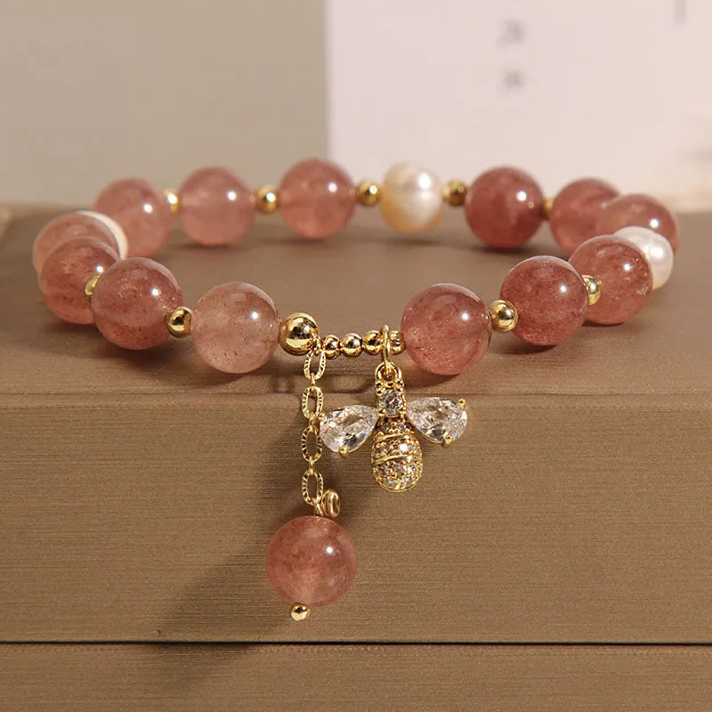 Women's bracelet with strawberry quartz beads, freshwater pearls, and zircon accents on an alloy setting.