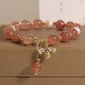 Women's bracelet with strawberry quartz beads, freshwater pearls, and zircon accents on an alloy setting.