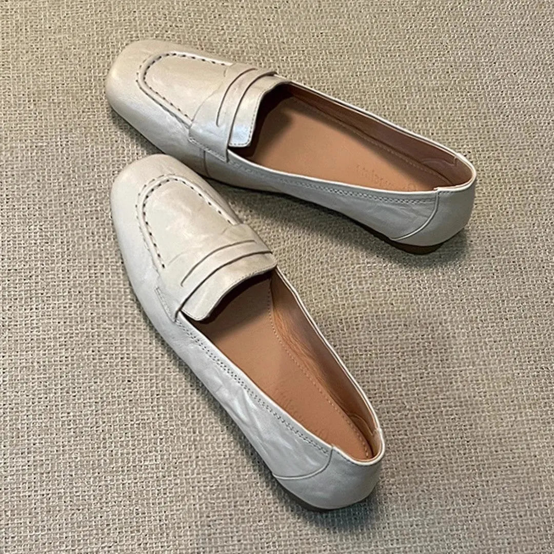 Beige white women's square toe flat shoes with cowhide upper and low heel on a plain background