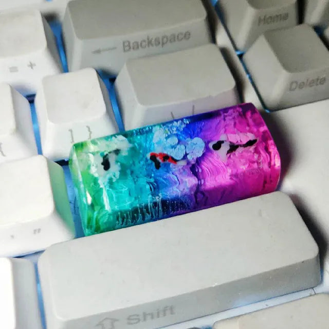 Resin keycap with koi fish swimming through scenery design for Cherry MX mechanical keyboards