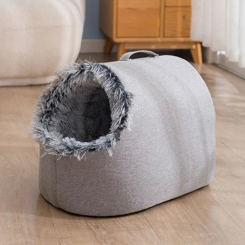 Grey fleece-lined enclosed cat sleeping bag bed for pets in a cage.