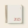 Cherry red spiral-bound coil notebook with wire binding lying flat on surface