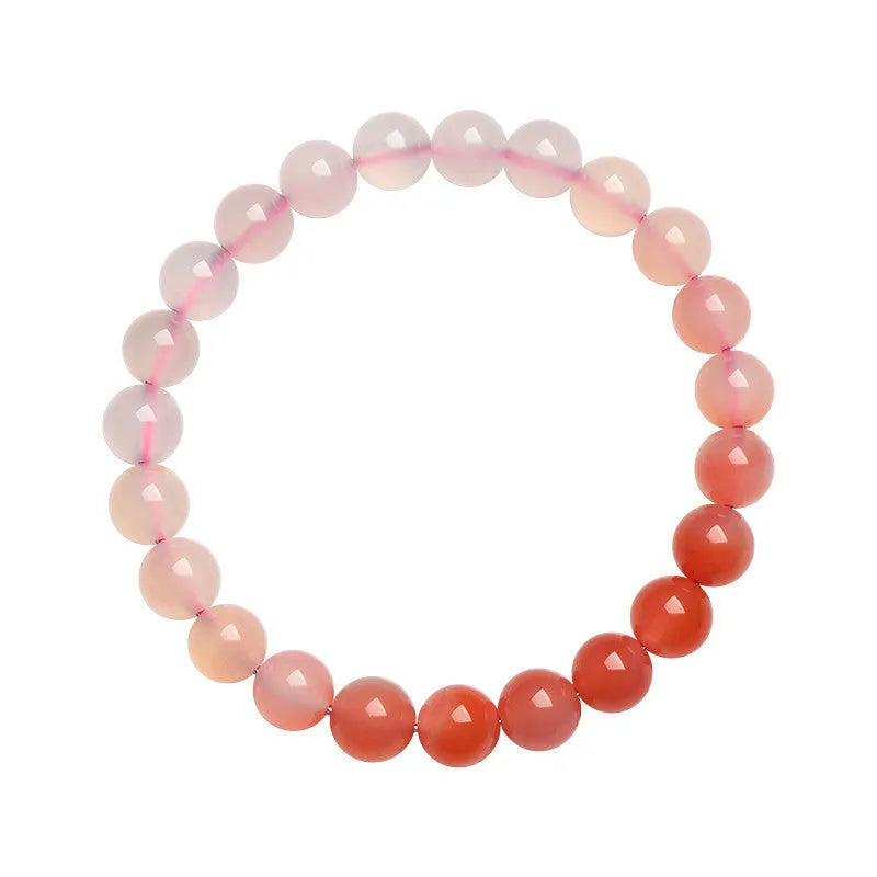 Natural gradient Yanyuan agate bracelet with geometric cut beads on a wrist.