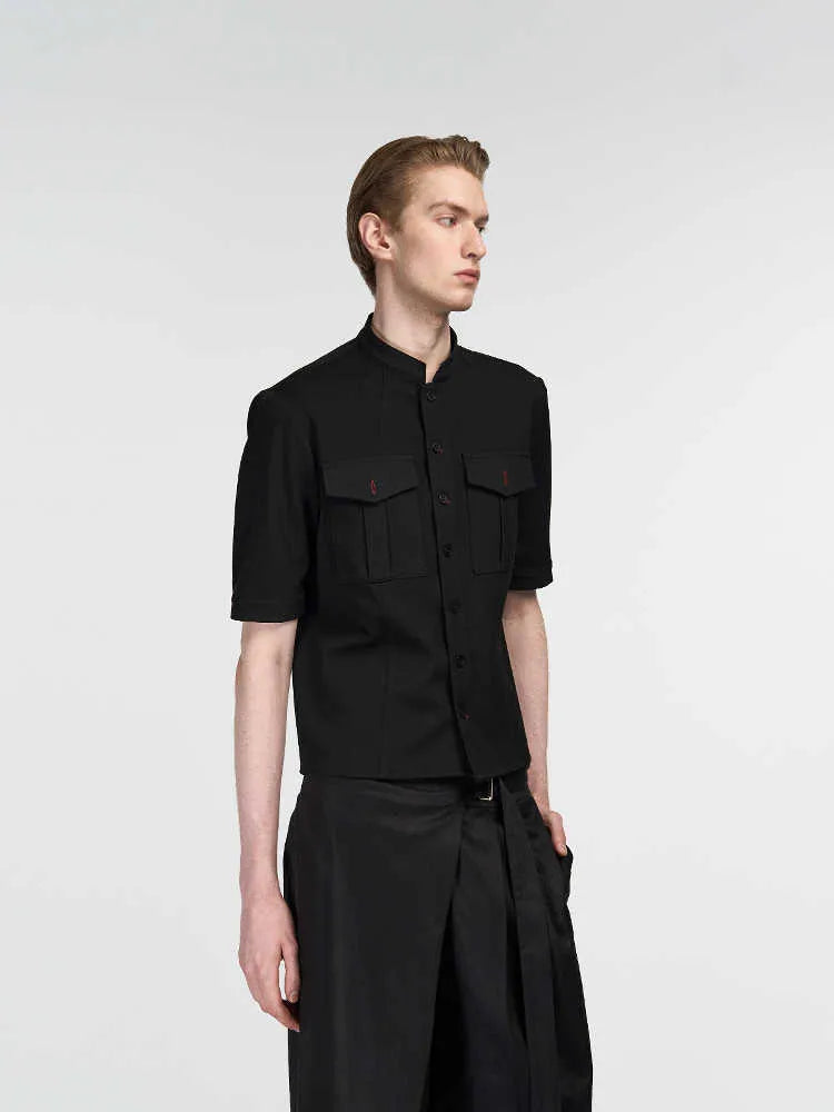 Handmade black half-sleeve shirt with a shirt collar and single-breasted front, shown in a loose fit.