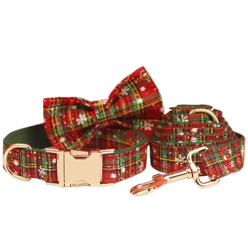 Green snowflake Christmas pet collar set with matching dog leash, bow decoration and vest in four-piece bundle