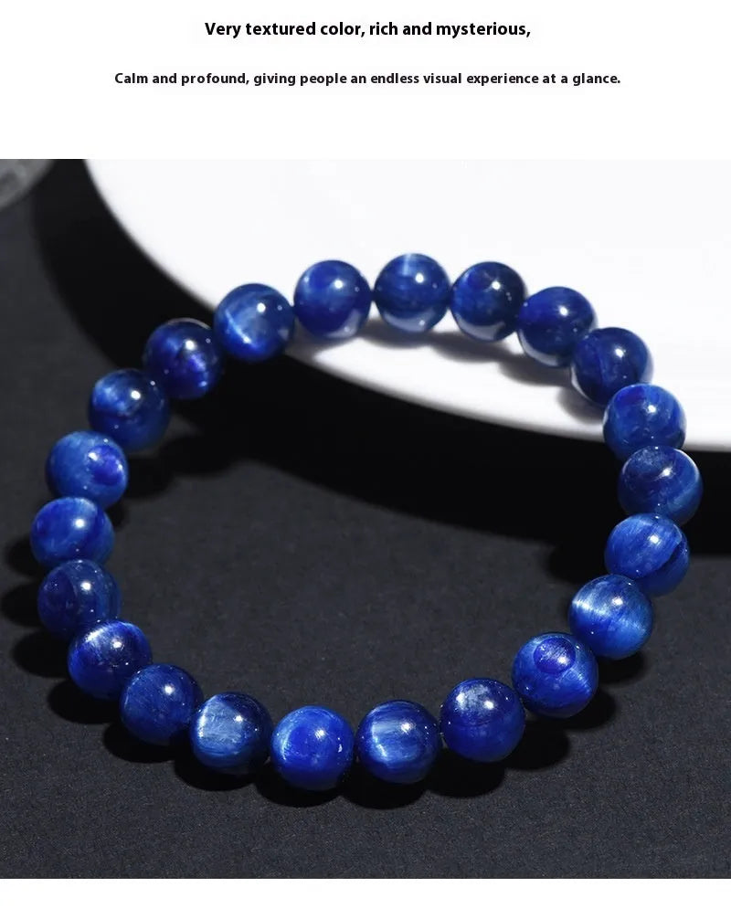 Natural blue crystal ball bracelet with geometric Ruyi design on a wrist.