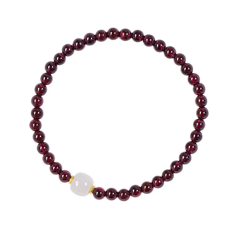 Women's garnet bracelet with U-shaped design showing polished stones in garnet colour