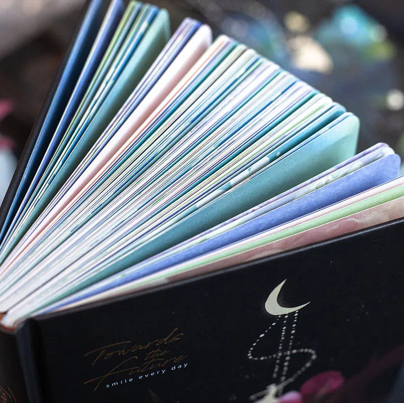A5 size notebook with a luminous reflective cover, open to show internal pages with colour illustrations.