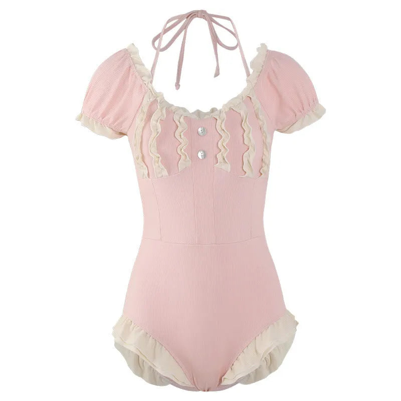 Pink Siamese style conservative one-piece swimsuit for women on a hanger