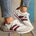 Wine red casual sneakers with cross straps over a breathable mesh and synthetic leather upper.