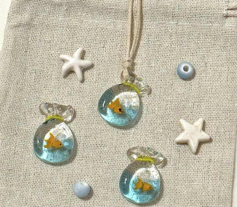 Women's pendant necklace with a coloured glaze skirt-shaped joker charm on a cotton and linen clavicle chain.