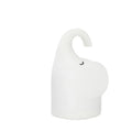 White silicone elephant-shaped night light with a warm glow, placed on a wooden bedside table.