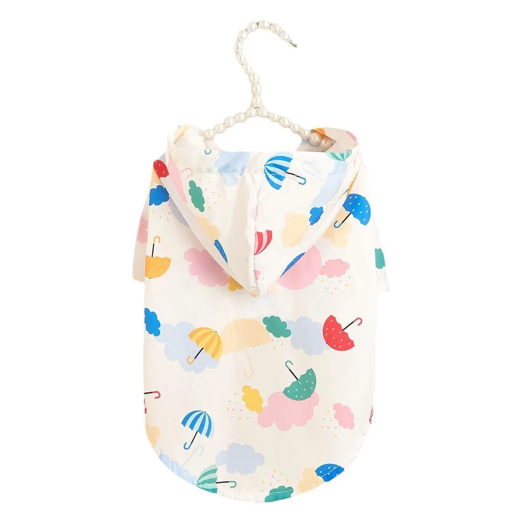 Colourful cartoon umbrella pattern dog raincoat on a model, showing the polyester fabric and size options.