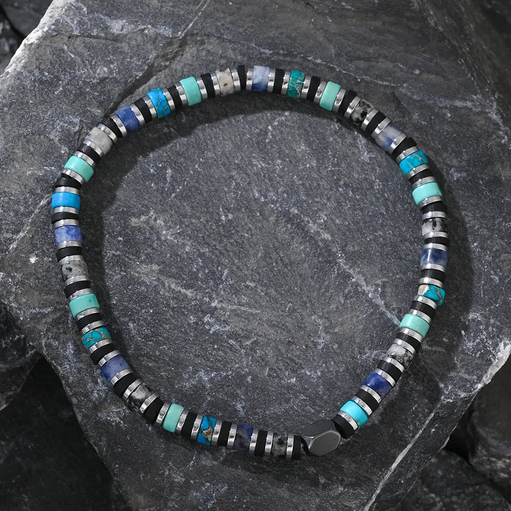 Hand-woven cylindrical bracelet with geometric pattern of natural semi-precious stones.